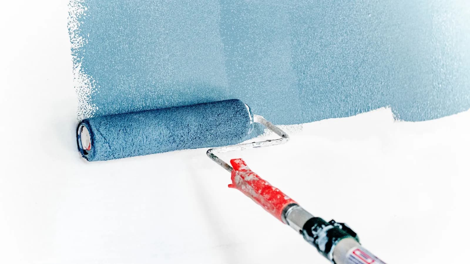 Professional painter applying a fresh coat to an interior wall